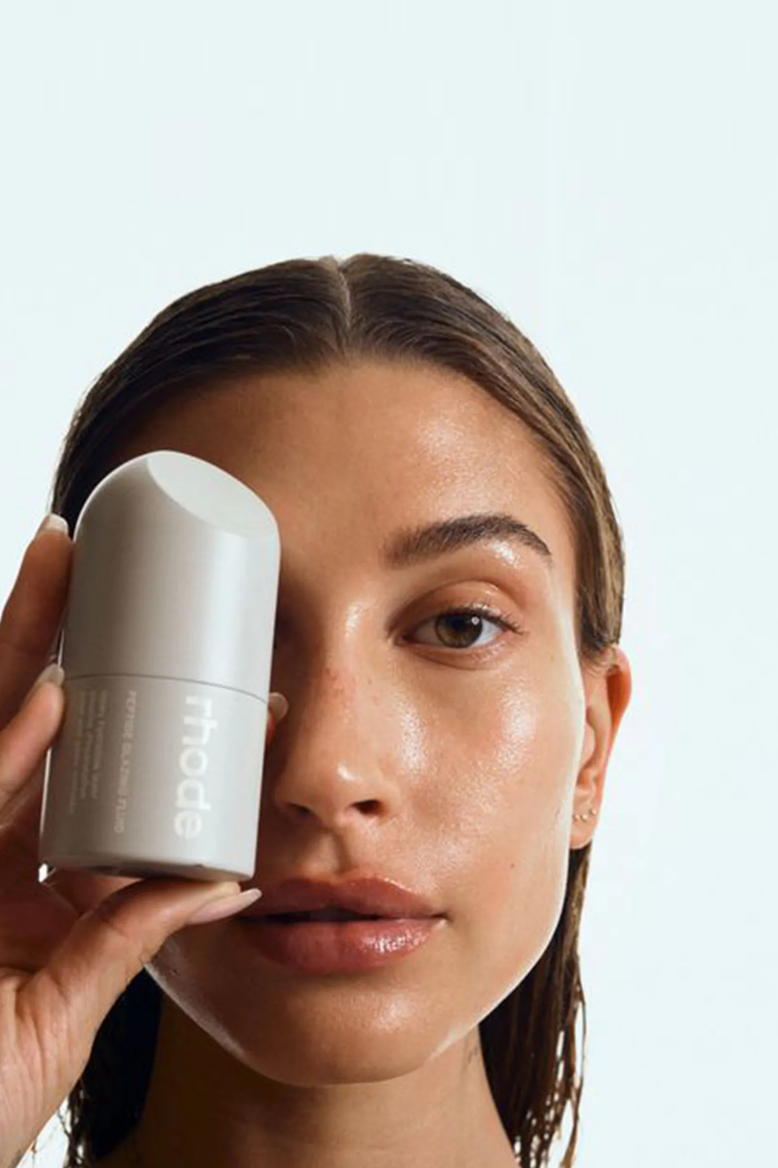 Rhode campaign, glazed clean-girl look, holding the Peptide Glazing Fluid